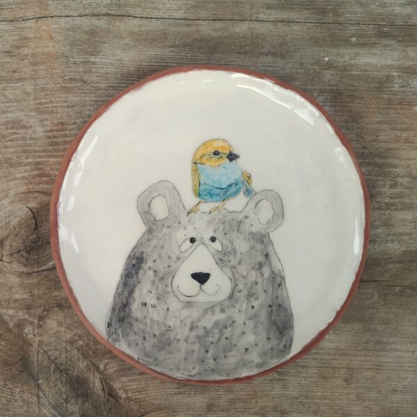 Hand painted ceramic decorative plate with bear and bird illustration